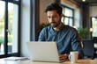 © Vera - Millennial Entrepreneur Multitasking on Laptop with Coffee in Stylish Office