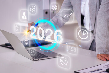 Wall Mural - Person writing 2026 year plan using laptop computer project future goals vision financial success business strategy technology modern office