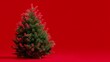 © fotofabrika - Decorative green Christmas tree against plain red background for holiday celebrations