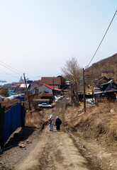 Wall Mural - tourists on dirty road in petropavlovsk-kamchatsky