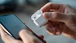 © Dace - Person connecting wireless earbuds to smartphone device