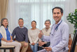 © Verin - portrait a doctor or psychologist in uniform with stethoscope holding tablet computer,sitting in counselling room,background blurred elderly group therapy