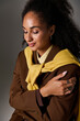 © LIGHTFIELD STUDIOS - Captivating autumn fashion on a beautiful African American woman in a studio setting