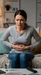 © Katsyarina - Woman gripping her stomach in pain. Female suffering from abdominal discomfort, period ache, or indigestion. Health problem.