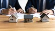 © vickryab - Real estate deal signing with miniature houses, property investment concept, home buying agreement, mortgage loan application, financial planning