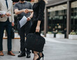 © qunica.com - Business professionals engaging in a handshake outside, depicting corporate collaboration in a modern urban setting.