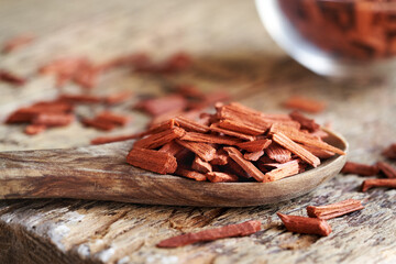 Wall Mural - Red sandalwood chips on a spoon on a table