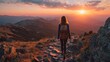 © Formoney - A person hikes along a rocky trail in the mountains as the sun sets on the horizon, casting a warm glow over the vast landscape. The natural beauty captivates the scene.