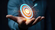 © Mst - Hand Holding Glowing Target with Arrow, Business Goal Achievement.