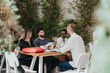 © qunica.com - A group of diverse business professionals conversing during an outdoor team meeting.