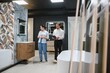 © Serhii - Woman choosing bathroom fixtures with sales assistant in showroom