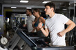 © JackF - Guy in sportswear runs on a treadmill in the gym. Young European doing cardio workout