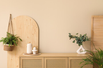 Wall Mural - Wooden chest of drawers, houseplant and folding screen near beige wall in living room