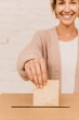 © Ryzhkov - Authentic Young Woman Voting at Polling Station Premium Positive Civic Engagement Content for Modern Lifestyle and Social Media Campaigns