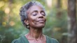 © Panuwat - Elderly African-American woman short curly hair standing forest relaxed Mature Black American