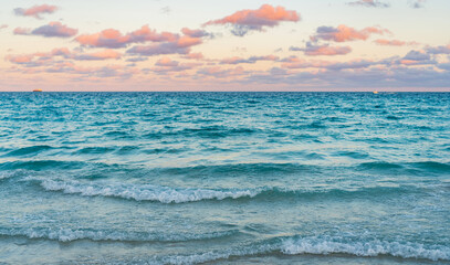 Wall Mural - Romantic summer vacation on sunset seascape. Sea sunset on ocean. Sunset seascape at summer vacation. Sunrise with sea beach. Dramatic sunrise horizon at sea. Sea waves