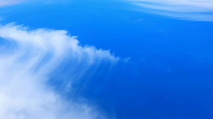 Wall Mural - Time-lapse effect of abstract, textured clouds gracefully moving across a vibrant blue sky during the day white, vibrant blue sky, scenery