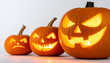 © ThabakStudio - Jack-o'-Lantern Lineup: A trio of carved pumpkins with expressive, glowing faces, each with their own unique persona, radiate the spirit of Halloween, from gentle smiles to menacing grins.
