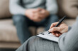 © Maksym - Therapist writing notes during a therapy session