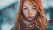 © Babb - Girl with bright red hair and striking blue eyes stands in falling snow. She wears an orange knit hat and a patterned scarf, creating a warm winter look against a snowy backdrop.