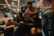 © qunica.com - Friends engaging in a casual video gaming experience together, sharing fun moments and laughter in a cozy arcade environment filled with energy and entertainment.