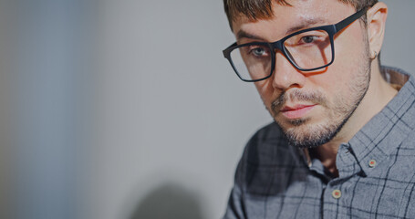 Closeup young adult male freelance developer typing write prompt AI bot app program nomad terminal with coding at office. Artificial intelligence dashboard, robotics, user interface, machine learning.