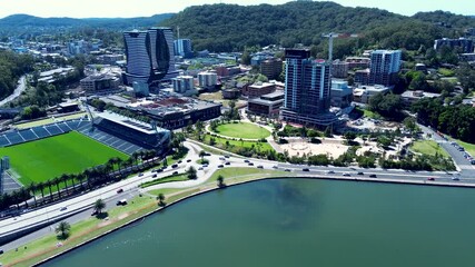 Wall Mural - Drone aerial landscape of traffic and cars driving around busy roundabout with Gosford city buildings urban infrastructure and waterfront on Central Coast Australia travel transport and tourism