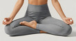 © Deliana Studio - Woman in Lotus Position Meditating, Wearing Gray Leggings, Isolated on White