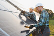 © Serhii - Engineers installing solar panels for clean energy production