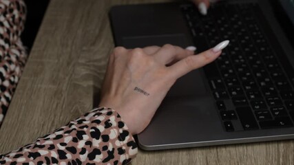 A female freelancer works at a computer and types on a keyboard.
Working at a computer in an office and modern technology.
A female programmer sits at a desk with a laptop.