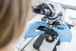 © NastyaPhoto - Female scientist using microscope in laboratory. Biotechnology specialist looking under microscope, doing analysis of test sample. Medical science laboratory: advanced equipment.
