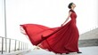 © TKN - Fashion woman in fluttering red long dress