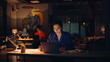 © stockbusters - Teammates focused deadline job in night office. Smiling woman looking laptop