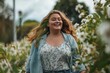 © nsit0108 - Plus size woman enjoying a walk in a park full of white flowers, feeling happy and connected to nature