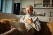 © Marko Geber - Senior man using laptop at home