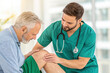 © Mr Cudling Pong - Doctor examining elderly man s knee during medical examination