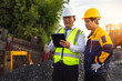 © ORG - Construction Team on Site: Two construction workers, dressed in safety vests and helmets, reviewing construction plans, demonstrating expertise and collaboration in a dynamic work environment.