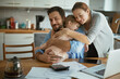 © Geber86 - Family embracing in kitchen