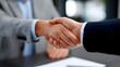 © pkproject - Two businessmen in suits shaking hands to finalize a professional partnership or business deal, symbolizing trust, coope n, and a successful collabo n.