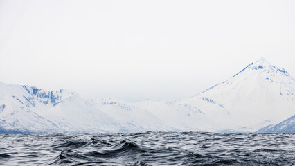 Wall Mural - waves and snow-covered shore in avacha bay