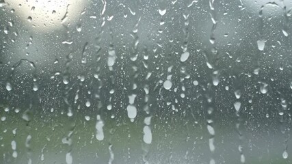Wall Mural - Timelapse of hailstones rapidly striking a glass window pane and melting into streams pane, texture, striking