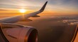 © Bat - A breathtaking sunrise view from an airplane window, highlighting the aircraft wing above clouds and distant landscapes, capturing the excitement and wonder of air travel and global exploration.