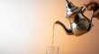 © capslock - Pouring traditional Moroccan mint tea from an ornate silver teapot into a glass cup