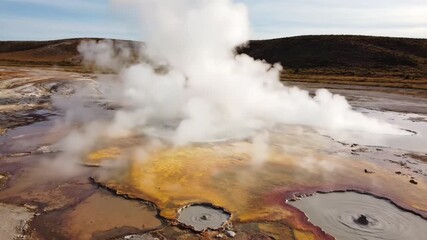 Wall Mural - steaming geothermal landscape with vibrant mineral deposits and rising vapor, illustrating active vo