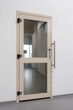 © karim - Modern light wood and glass interior door with a long steel handle set in a white wall.