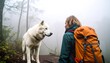© karepmu - Woman Hiking with Dog in Foggy Forest.