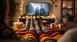 © Tiana_Geo - Family enjoys cozy autumn evening watching movie at home. Parents and child relax on couch under warm blankets with feet up, eating popcorn.