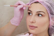 © Maria - Cosmetologist drawing mark on client face to prepare for rejuvenation treatment