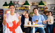 © JackF - Company of young adult sports supporters with national flag of England upset about favorite team losing match in bar