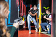 © JackF - Positive girl holding laser pistol playing laser tag game with his friends